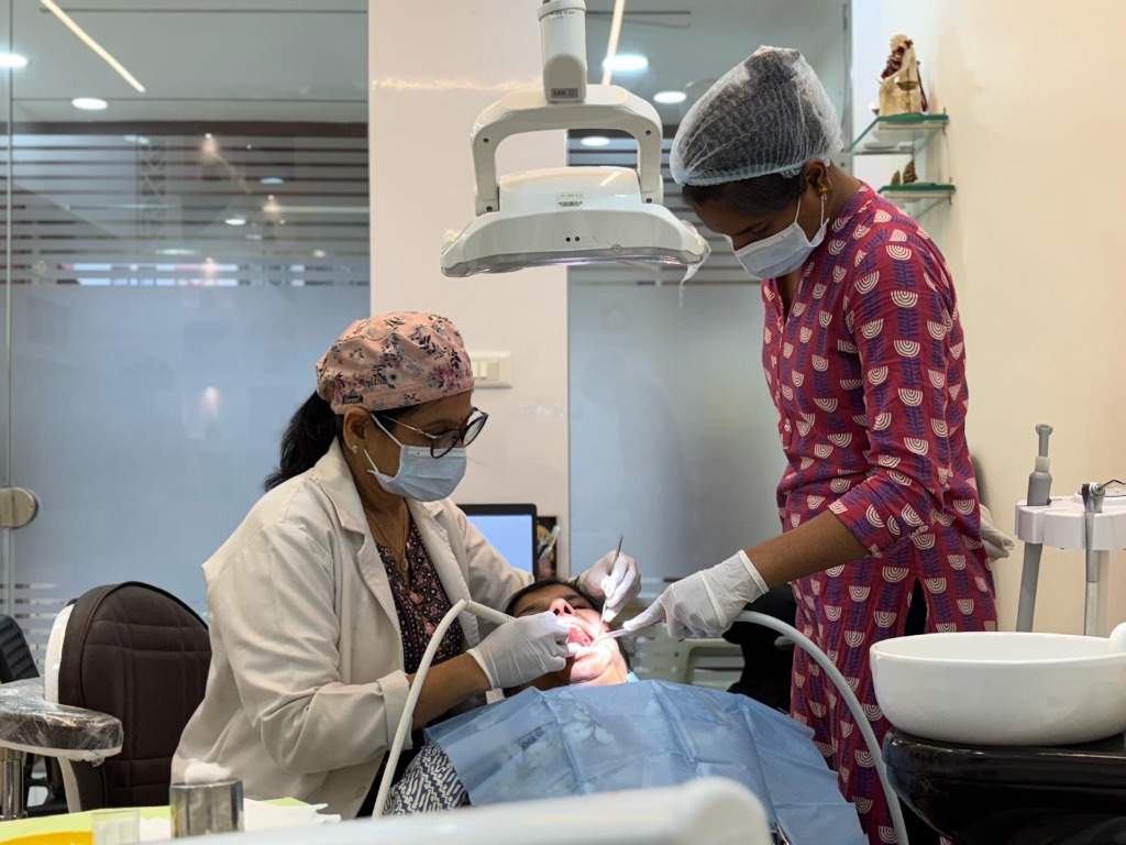 Dr. Anitha performing dental treatment